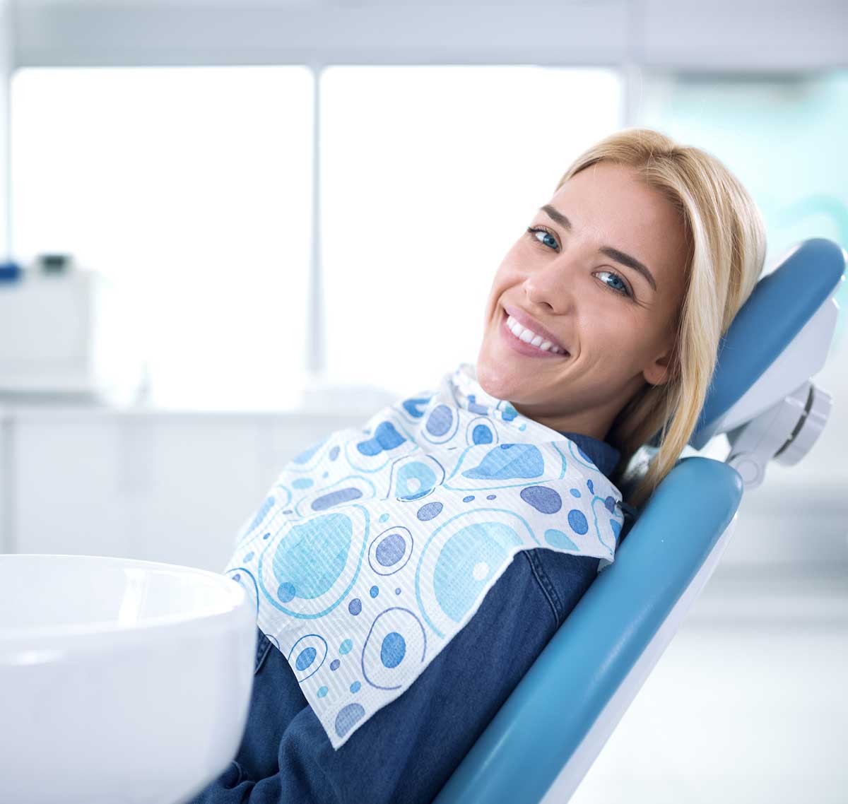 Smiling,And,Satisfied,Patient,In,A,Dental,Office,After,Treatment